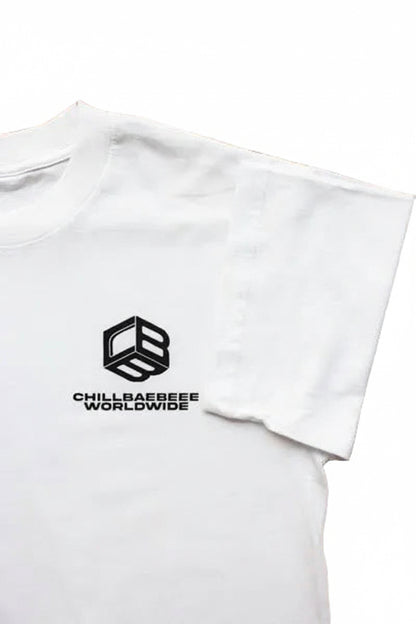 Close-up of the CBB Cube and CHILLBAEBEEE WORLDWIDE logo on the Classic Logo White Tee